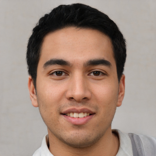 Joyful white young-adult male with short  black hair and brown eyes