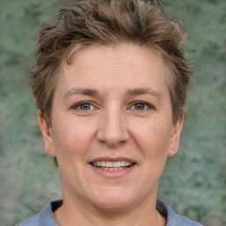 Joyful white adult female with short  brown hair and grey eyes