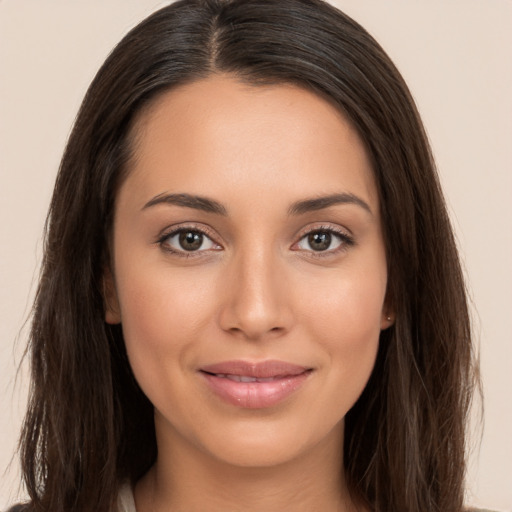 Joyful white young-adult female with long  brown hair and brown eyes