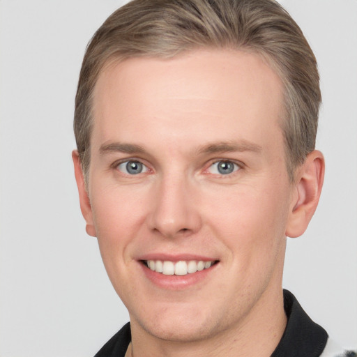 Joyful white adult male with short  brown hair and grey eyes