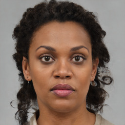 Joyful black young-adult female with medium  brown hair and brown eyes