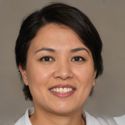 Joyful white adult female with medium  brown hair and brown eyes