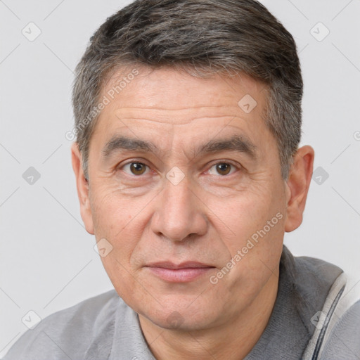 Joyful white middle-aged male with short  brown hair and brown eyes