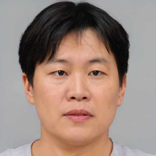 Neutral asian adult male with short  brown hair and brown eyes