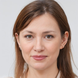 Joyful white young-adult female with long  brown hair and grey eyes