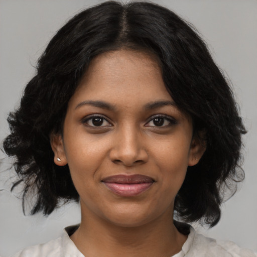 Joyful black young-adult female with medium  black hair and brown eyes