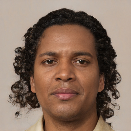 Joyful black young-adult male with medium  brown hair and brown eyes