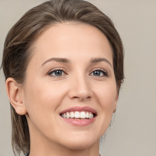 Joyful white young-adult female with medium  brown hair and brown eyes