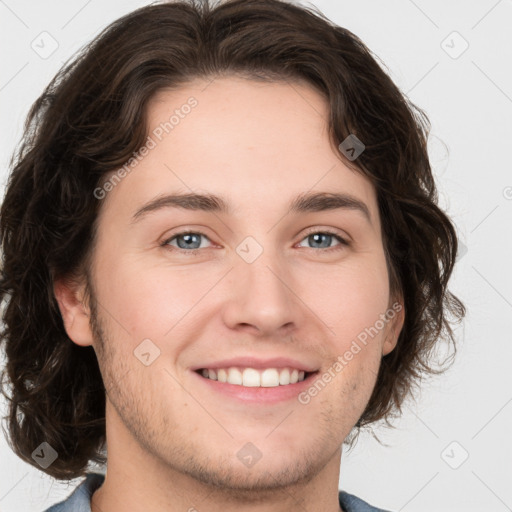 Joyful white young-adult male with medium  brown hair and brown eyes