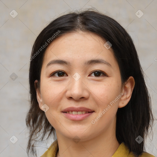 Joyful asian young-adult female with medium  brown hair and brown eyes