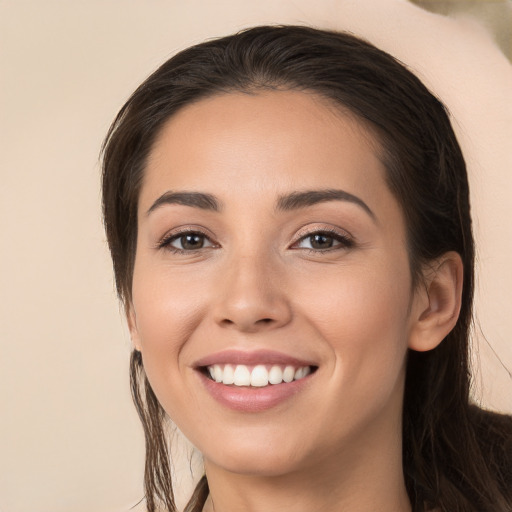 Joyful white young-adult female with long  brown hair and brown eyes