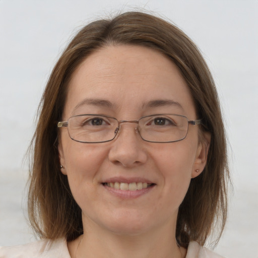 Joyful white adult female with medium  brown hair and brown eyes