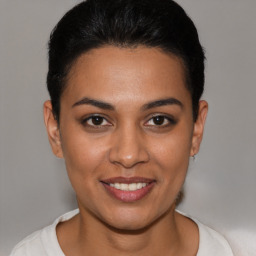 Joyful latino young-adult female with short  brown hair and brown eyes