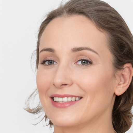 Joyful white young-adult female with medium  brown hair and blue eyes