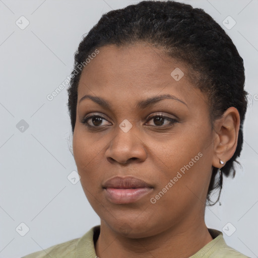 Joyful black young-adult female with short  black hair and brown eyes