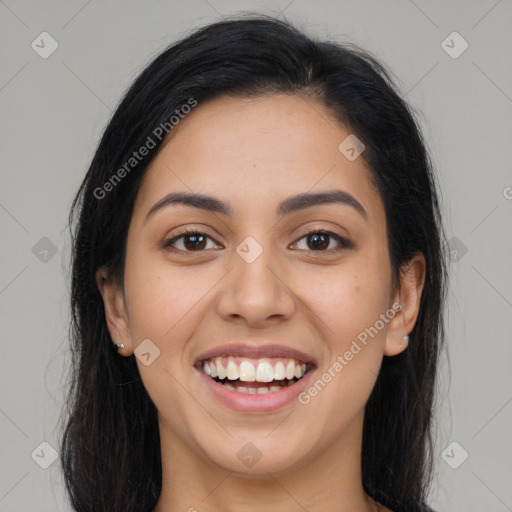 Joyful latino young-adult female with long  brown hair and brown eyes