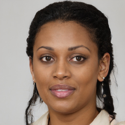Joyful black young-adult female with long  black hair and brown eyes