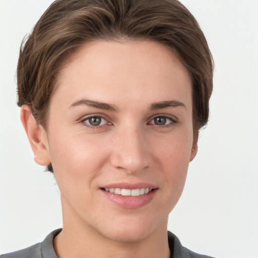 Joyful white young-adult female with short  brown hair and grey eyes