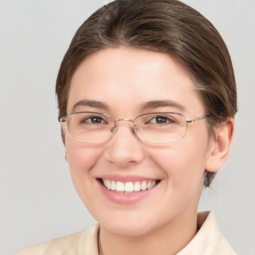 Joyful white adult female with medium  brown hair and blue eyes