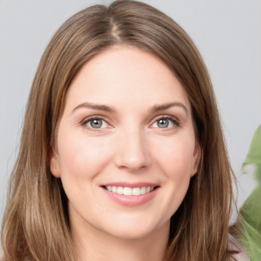 Joyful white young-adult female with long  brown hair and grey eyes