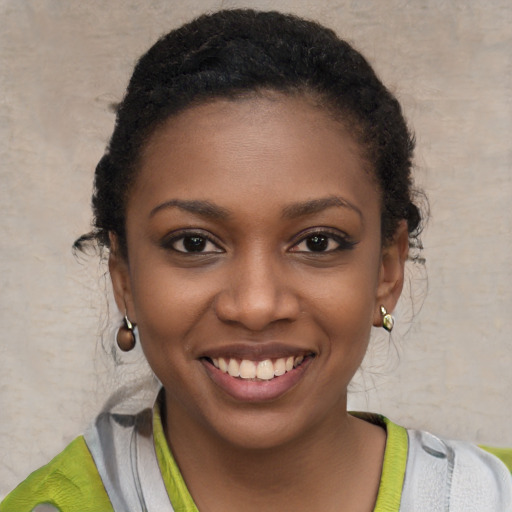 Joyful black young-adult female with short  brown hair and brown eyes