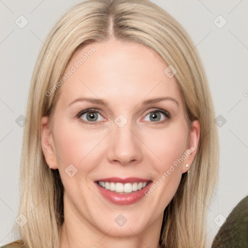 Joyful white adult female with long  brown hair and blue eyes