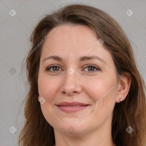 Joyful white adult female with long  brown hair and brown eyes