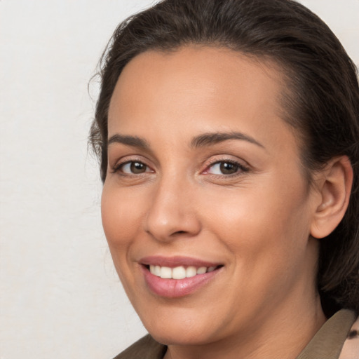 Joyful white young-adult female with medium  brown hair and brown eyes