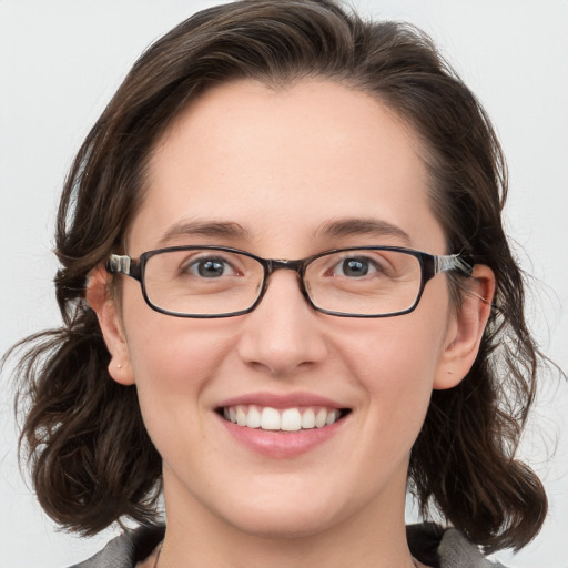 Joyful white young-adult female with medium  brown hair and blue eyes