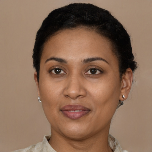 Joyful latino adult female with short  brown hair and brown eyes