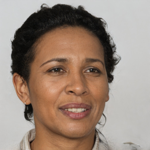 Joyful black adult female with short  brown hair and brown eyes