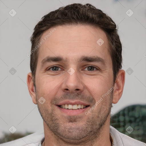 Joyful white adult male with short  brown hair and brown eyes