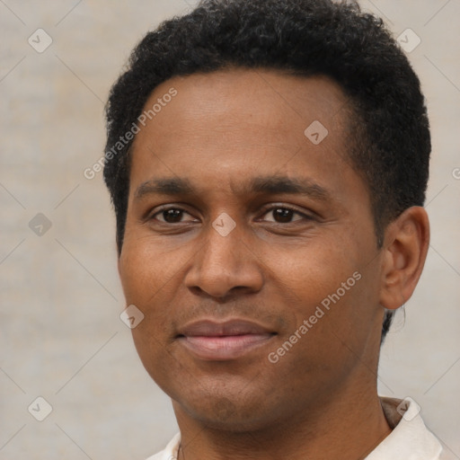 Joyful black young-adult male with short  black hair and brown eyes