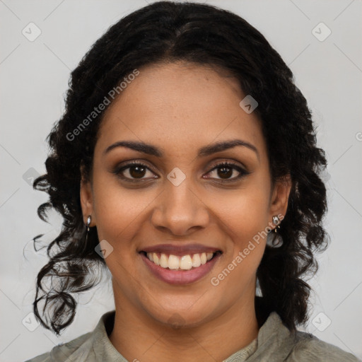 Joyful black young-adult female with long  black hair and brown eyes