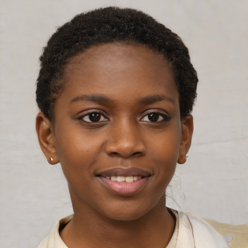 Joyful black child female with short  brown hair and brown eyes