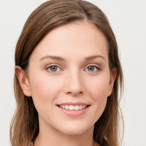 Joyful white young-adult female with long  brown hair and grey eyes