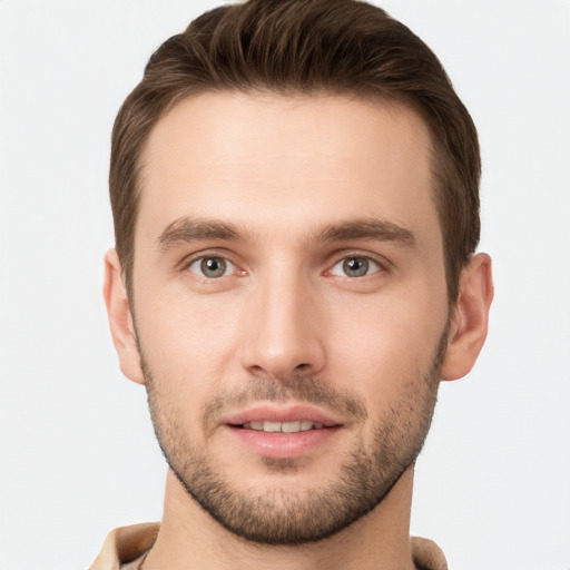 Joyful white young-adult male with short  brown hair and grey eyes