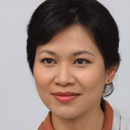 Joyful asian young-adult female with medium  brown hair and brown eyes