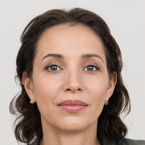 Joyful white adult female with medium  brown hair and grey eyes