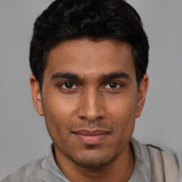 Joyful latino young-adult male with short  black hair and brown eyes