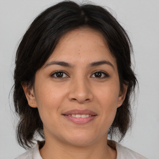 Joyful asian adult female with medium  brown hair and brown eyes