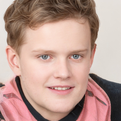 Joyful white child male with short  brown hair and blue eyes