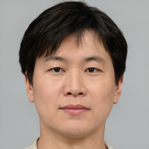 Neutral asian young-adult male with short  brown hair and brown eyes