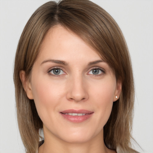 Joyful white young-adult female with medium  brown hair and grey eyes