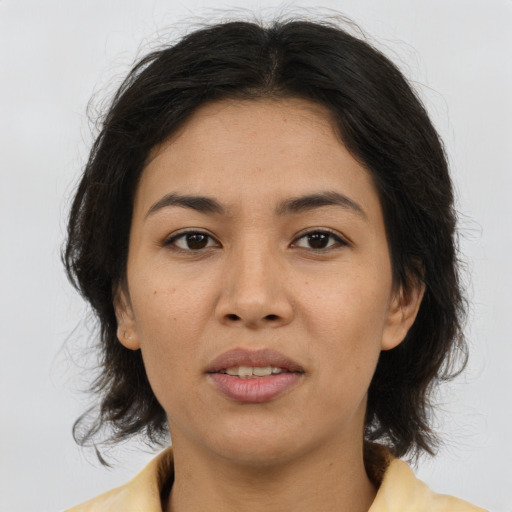 Joyful asian adult female with medium  brown hair and brown eyes