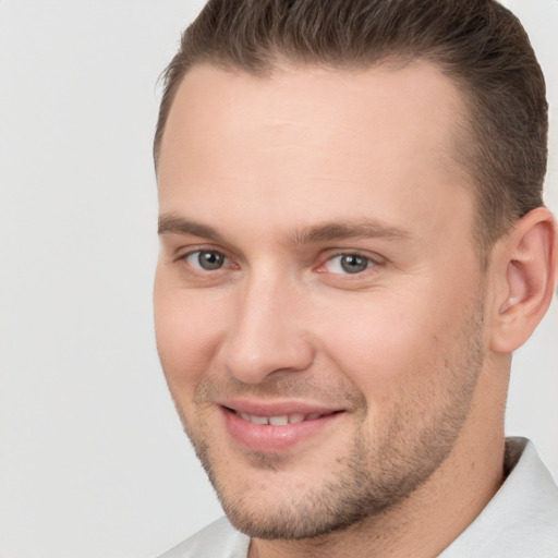 Joyful white young-adult male with short  brown hair and brown eyes