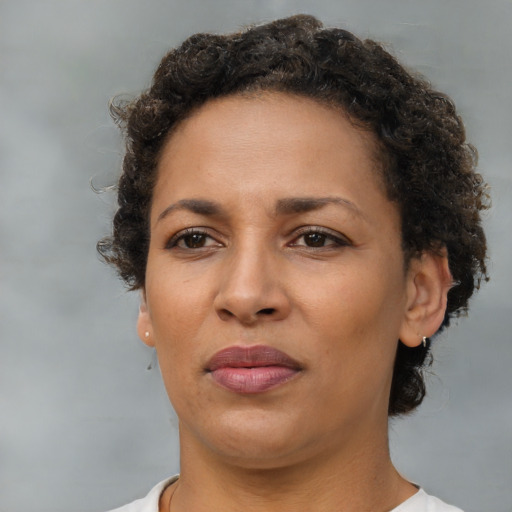 Joyful latino adult female with short  brown hair and brown eyes