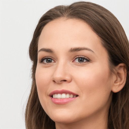 Joyful white young-adult female with long  brown hair and green eyes