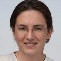 Joyful white adult female with medium  brown hair and brown eyes