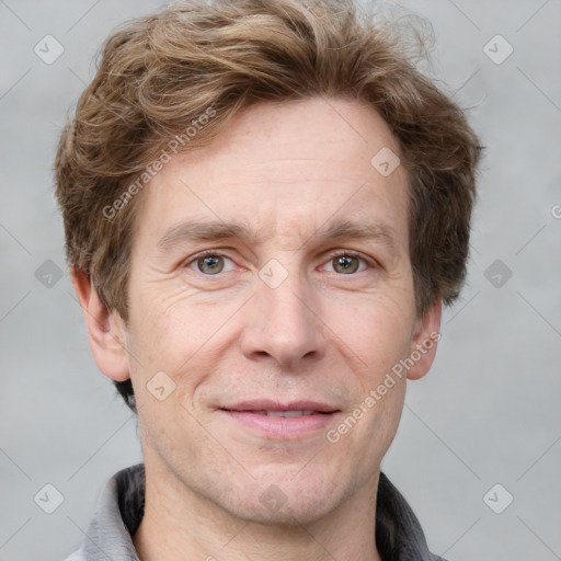 Joyful white adult male with short  brown hair and grey eyes